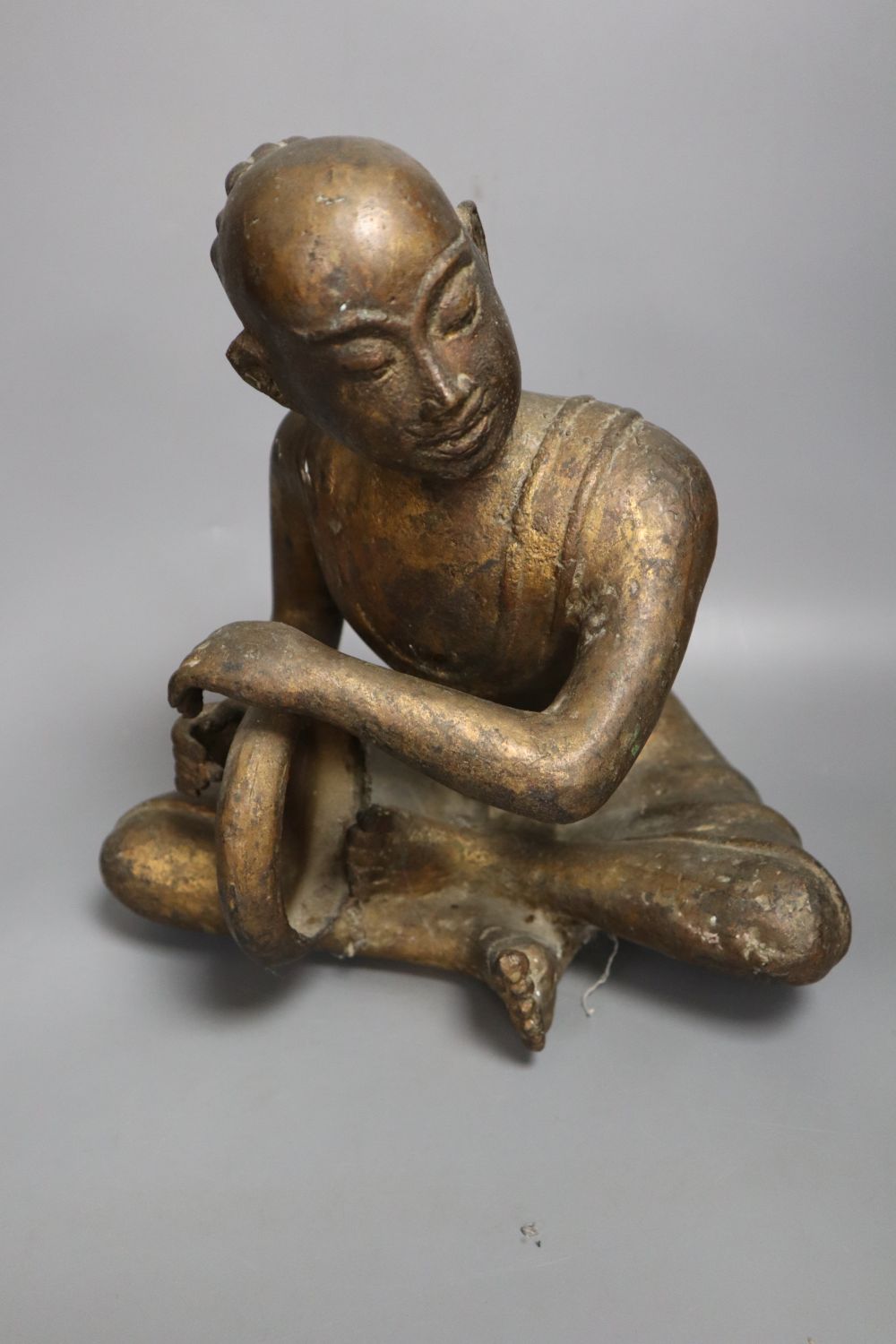 A South East Asian gilt bronze seated figure of a drummer, height 27cm